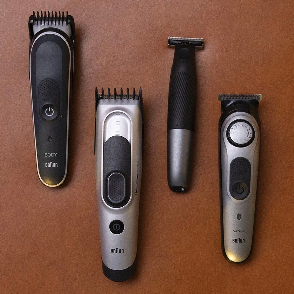 an set of electric shavers lying face-up on a wooden table