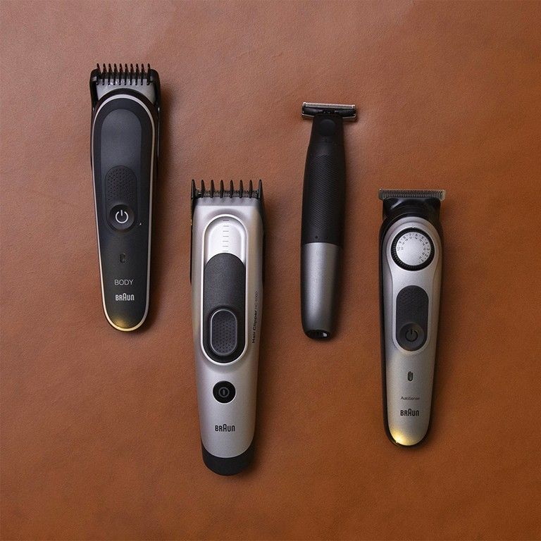 an set of electric shavers lying face-up on a wooden table